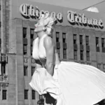 Statua di Marilyn Monroe, icona di stile, posta davanti a un edificio.