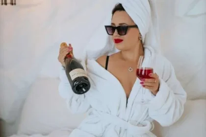 Donna single festeggia felicemente San Valentino con pizza, calice di vino, riviste di moda.